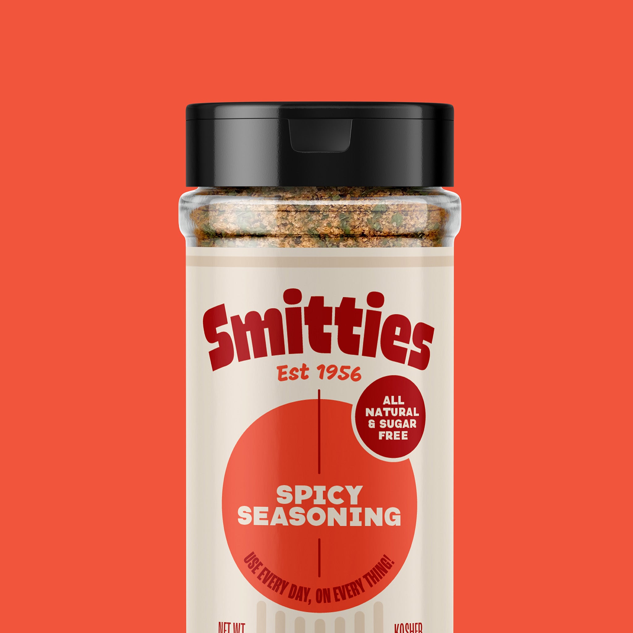 A shaker of Smitties Spicy Seasoning against a red background.